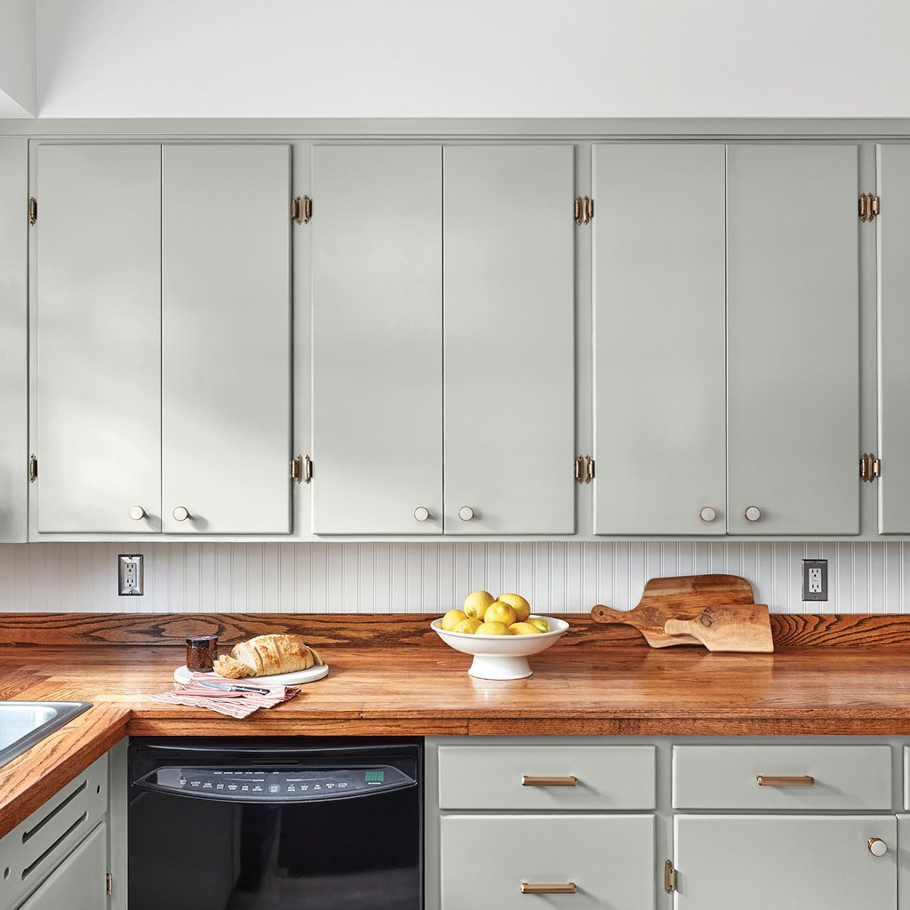 Kitchen with White Backsplash and Cupboards Painted in Valspar's Gray-Green Linen.