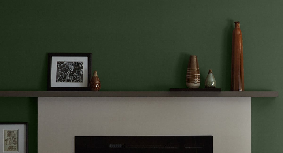 Deep Green Wall with a White Fireplace