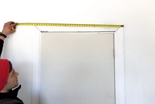 Man measures door frame